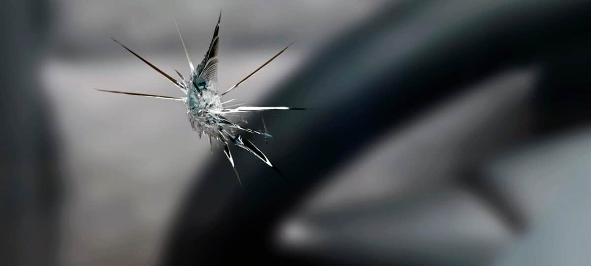 close up of a stone chip in the windshield of a car