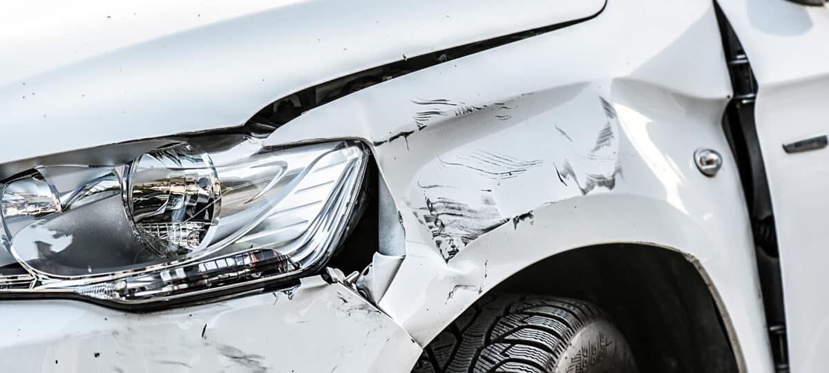 Front fender and light damage and scratches on bumper.