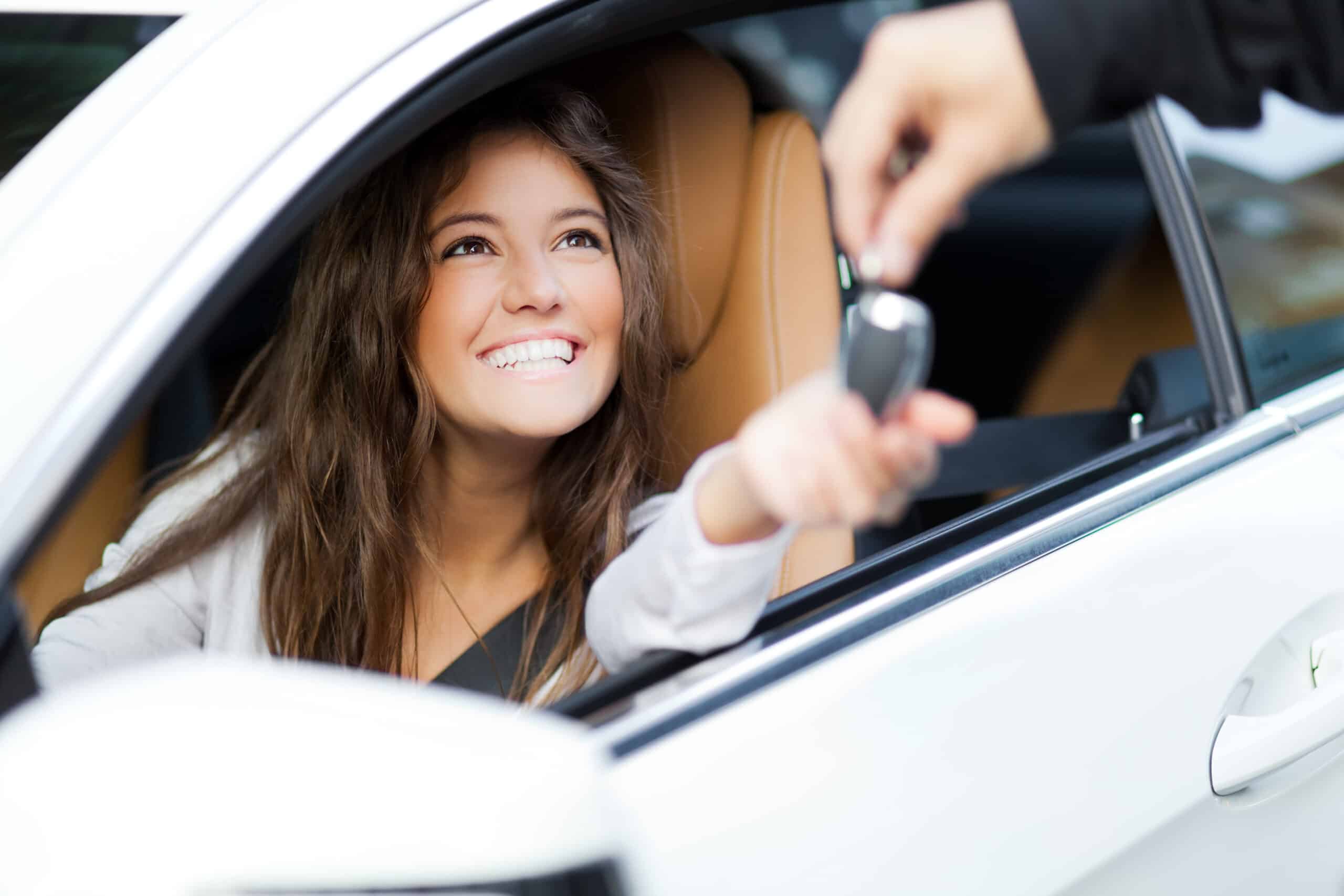 Woman receiving keys of her rental car